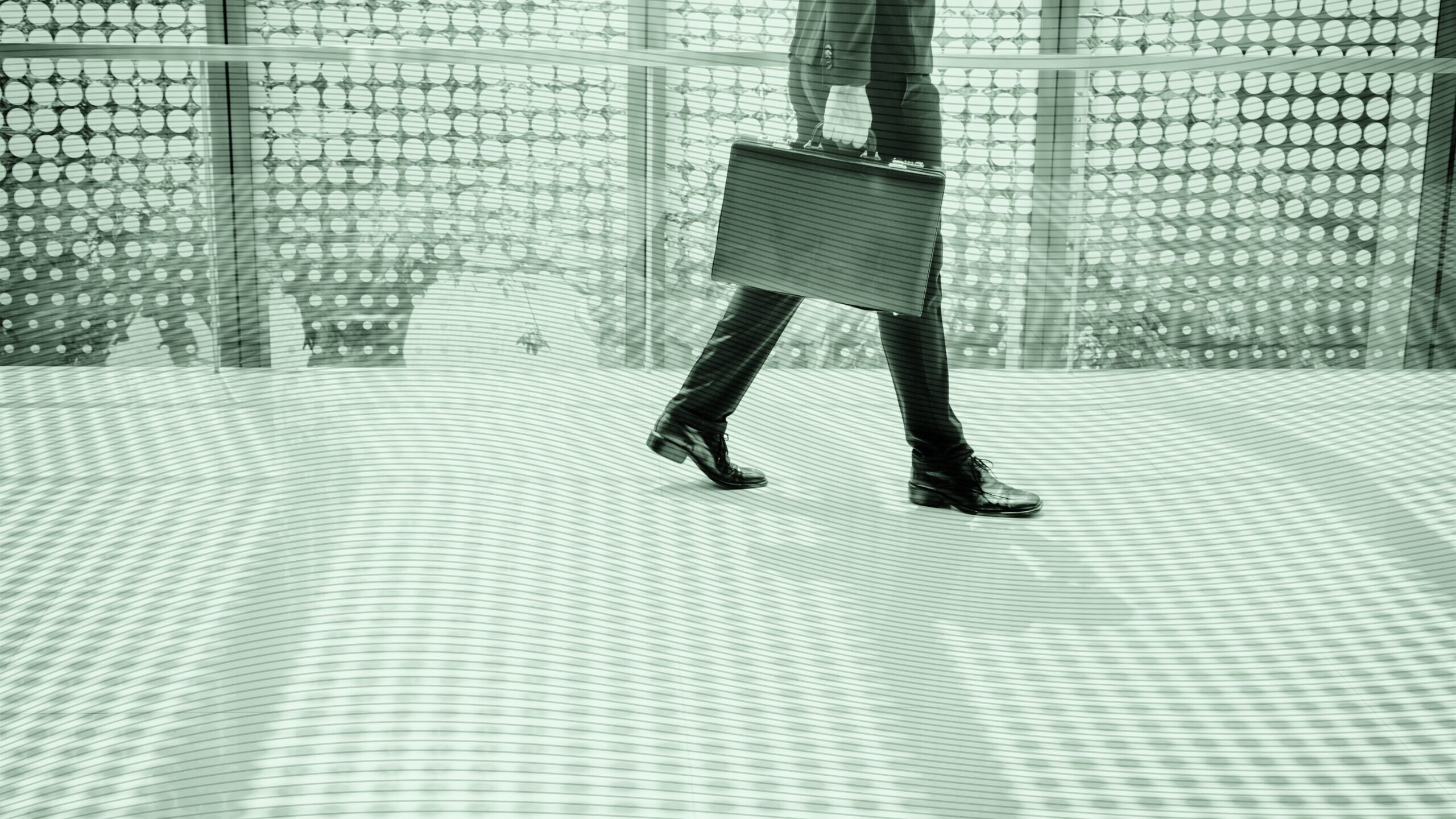 A business person walking with a briefcase.