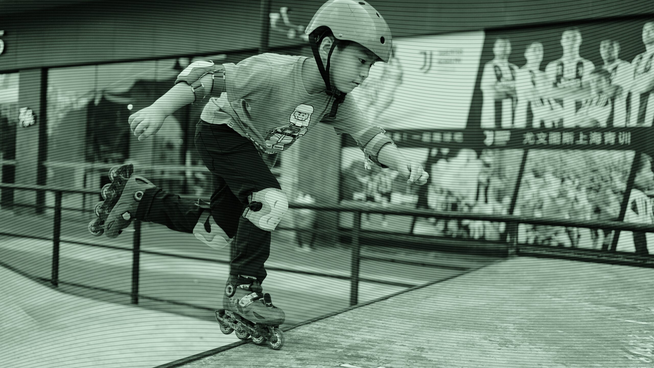 A kid in safety gear rollerblading.