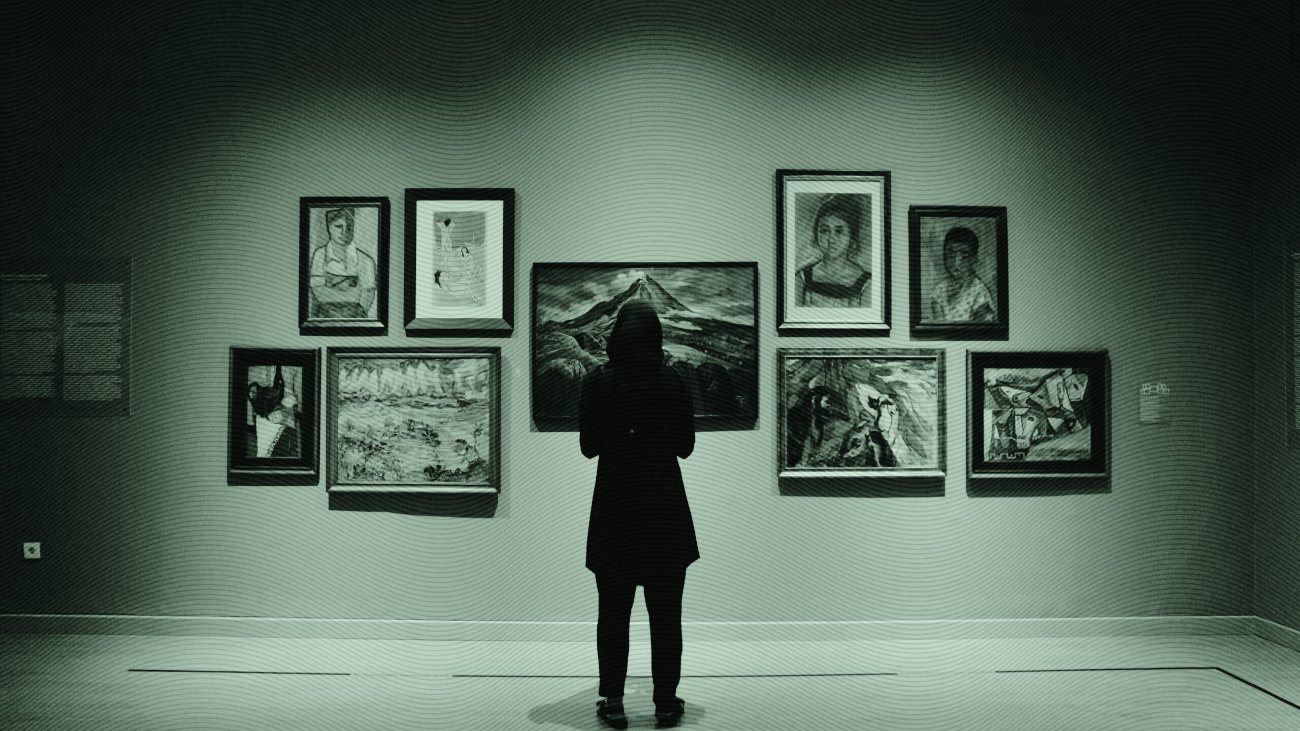 A woman looking at paintings.